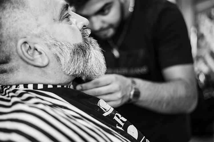 Barber Trimming Beard on Customer
